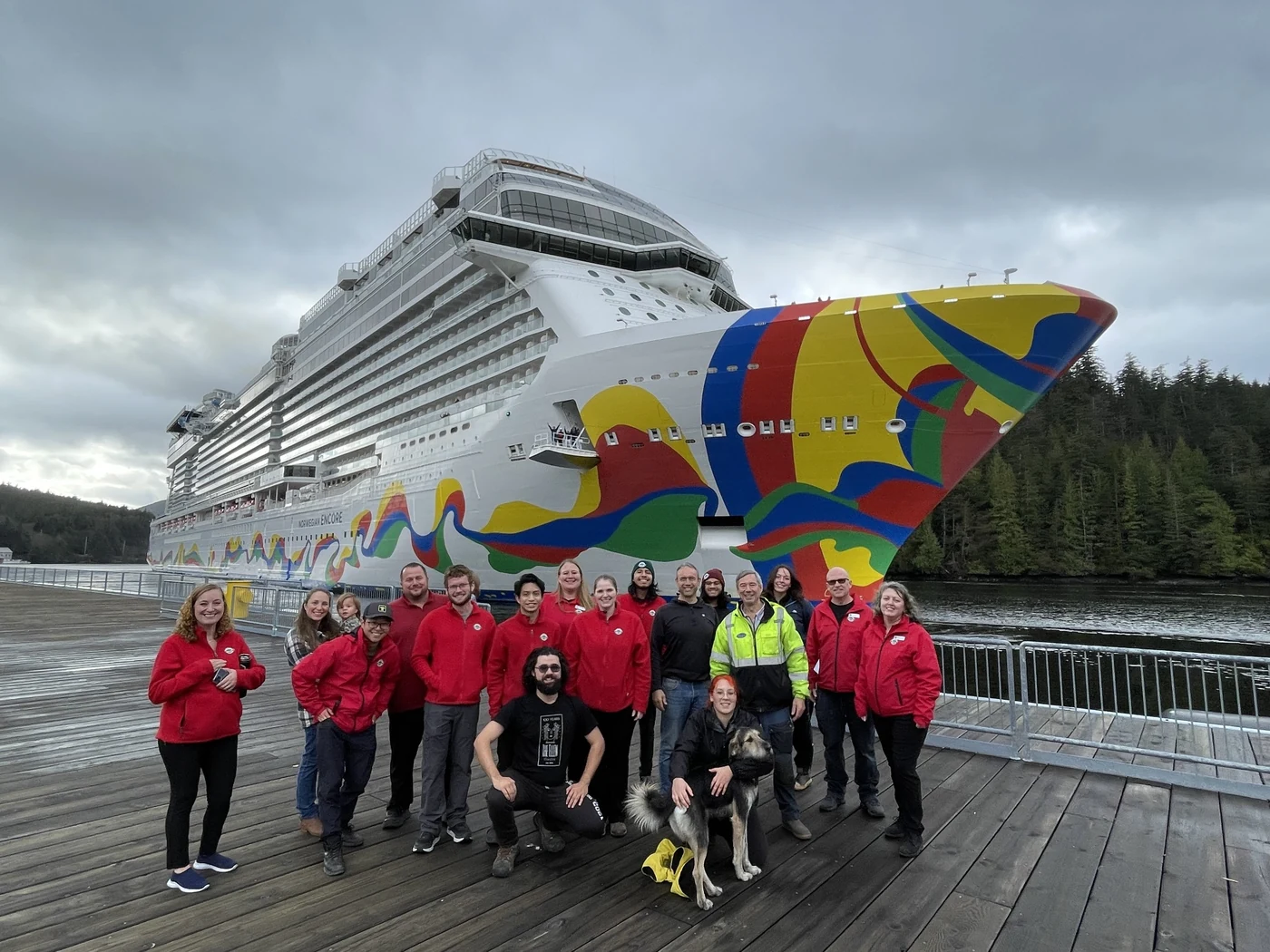 Port and tour operations team posing together beside a cruise ship in Alaska