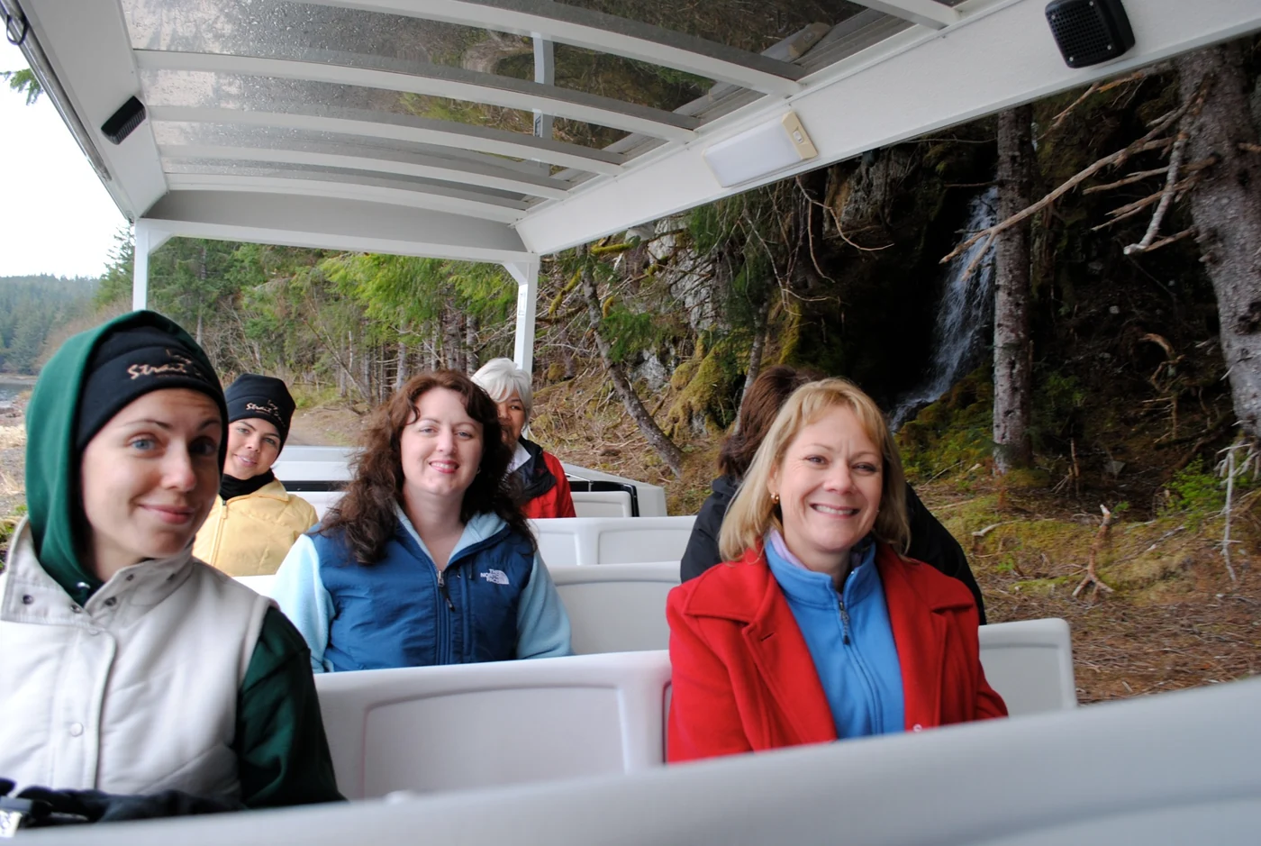 Visitors experiencing a guided tour in an open-air vehicle in Alaska
